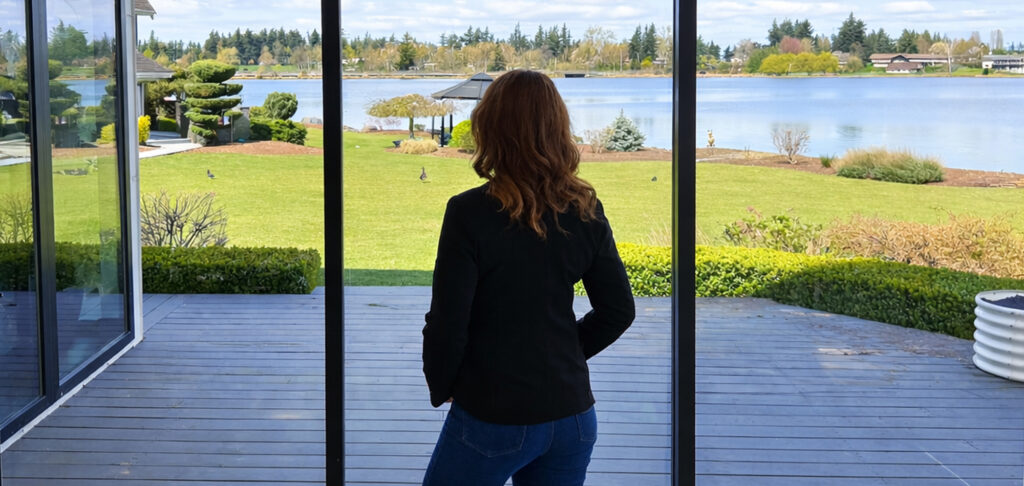 Jolene looking out at the water from a home’s deck